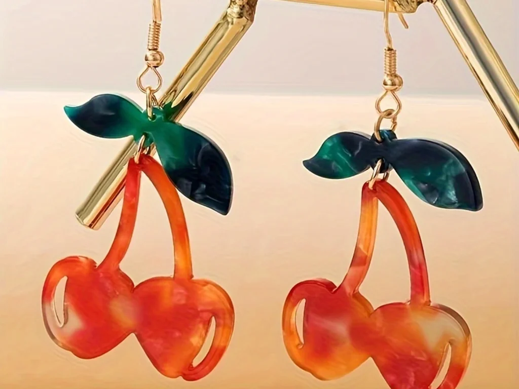 Resin Cherry Drop Earrings showing styling or color variation