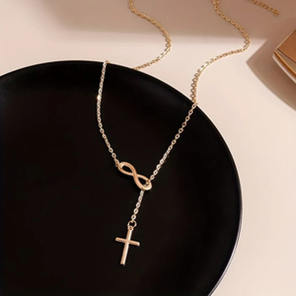 Gold-tone infinity cross necklace on black plate