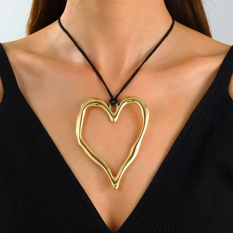 Gold-tone open heart pendant necklace worn on a model