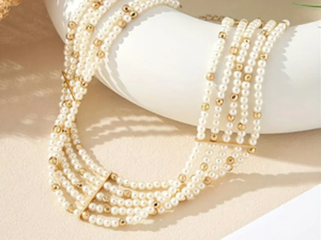 Layered faux pearl choker necklace draped on display