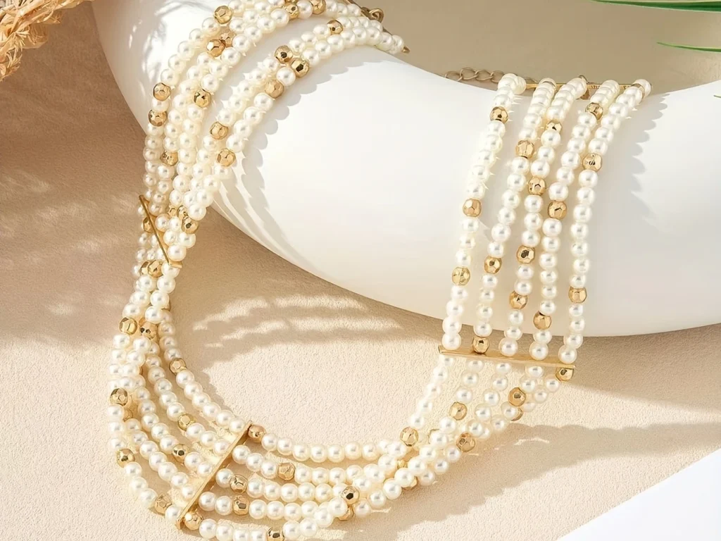 Pearl choker necklace arranged on a stand