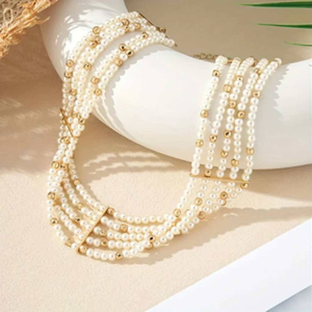 Layered faux pearl choker necklace draped display