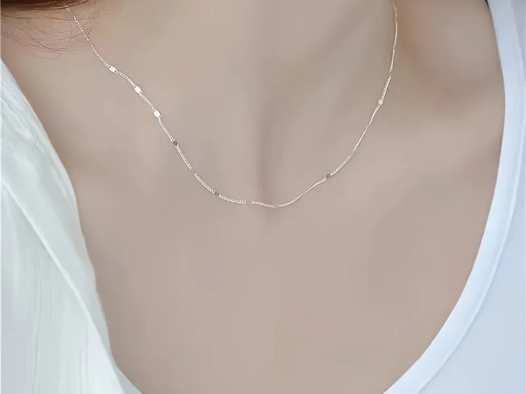 Silver-tone station necklace styled on a model