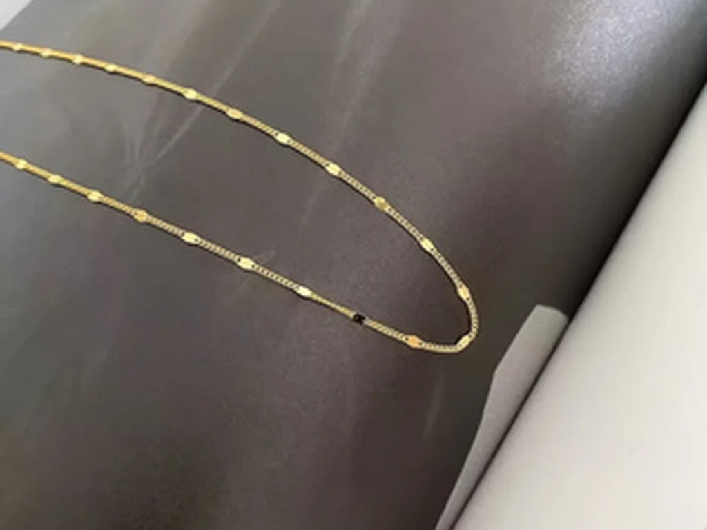Gold-tone station necklace close detail view