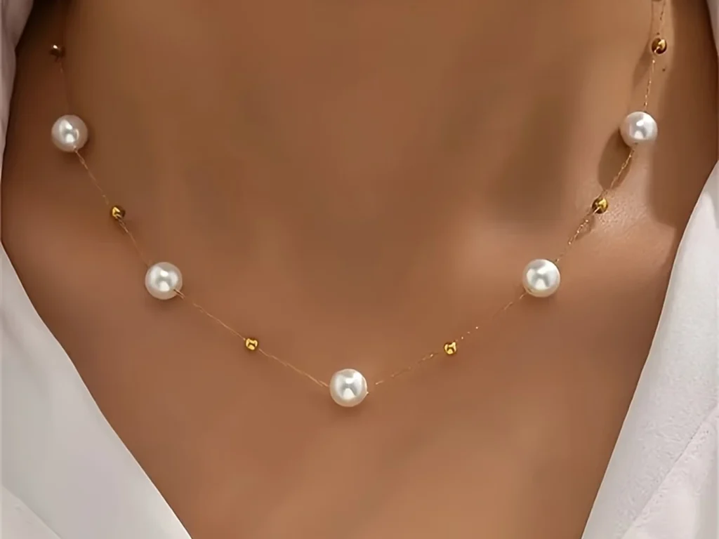 Pearl station necklace close-up worn view