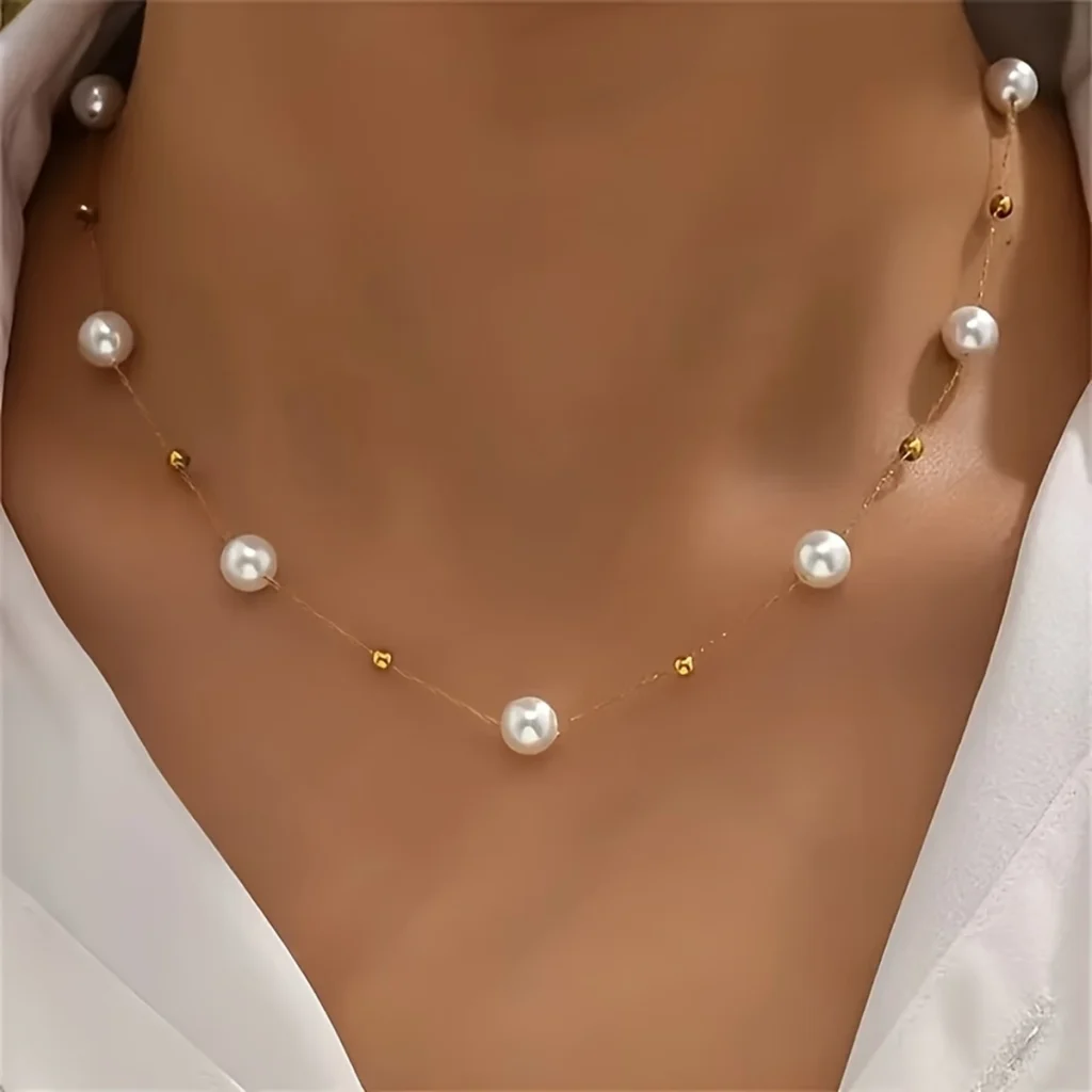 Pearl station necklace worn close to the neck