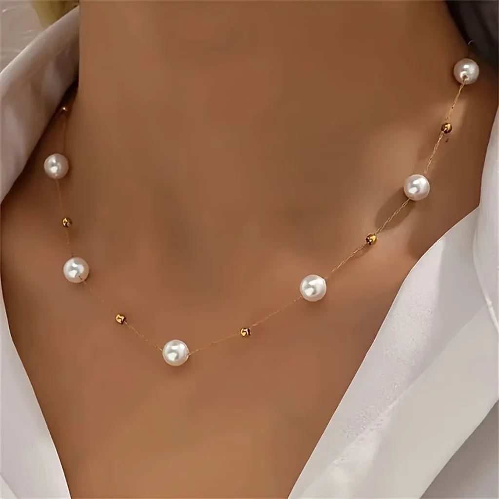 Dainty pearl station necklace styled on a model