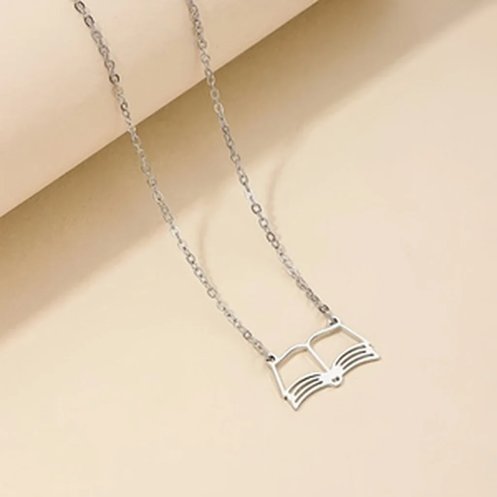 Silver-tone open book pendant necklace flat front view