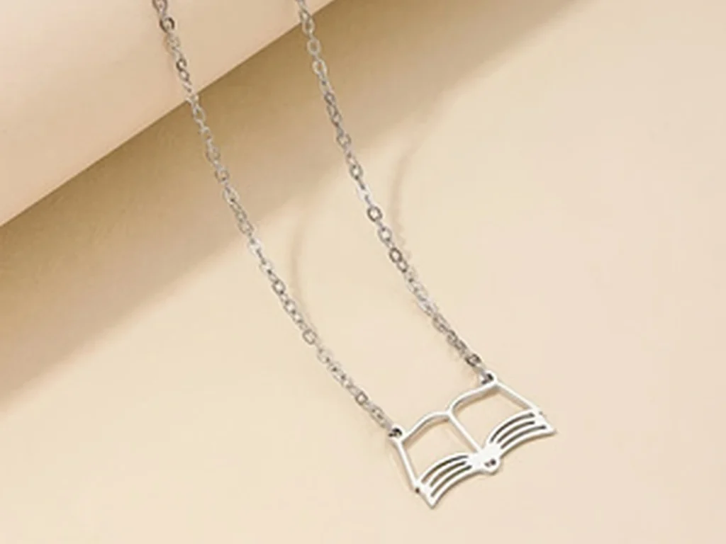Silver-tone open book pendant necklace front flat view