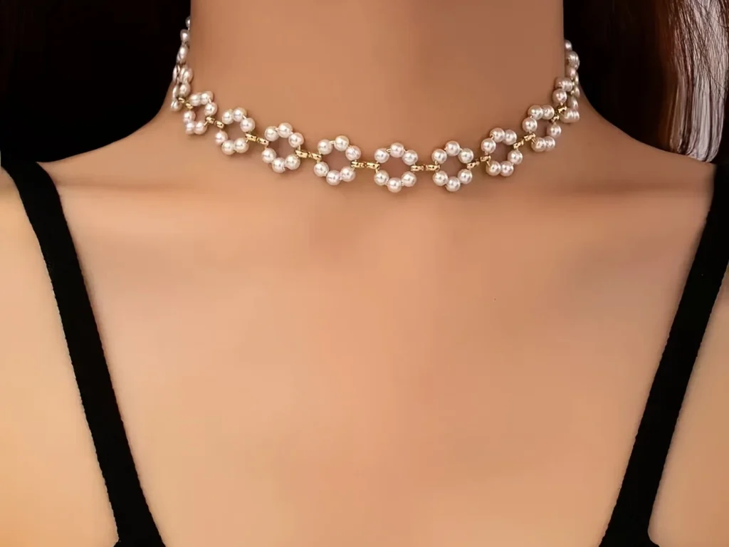 Pearl daisy choker necklace worn at the neckline