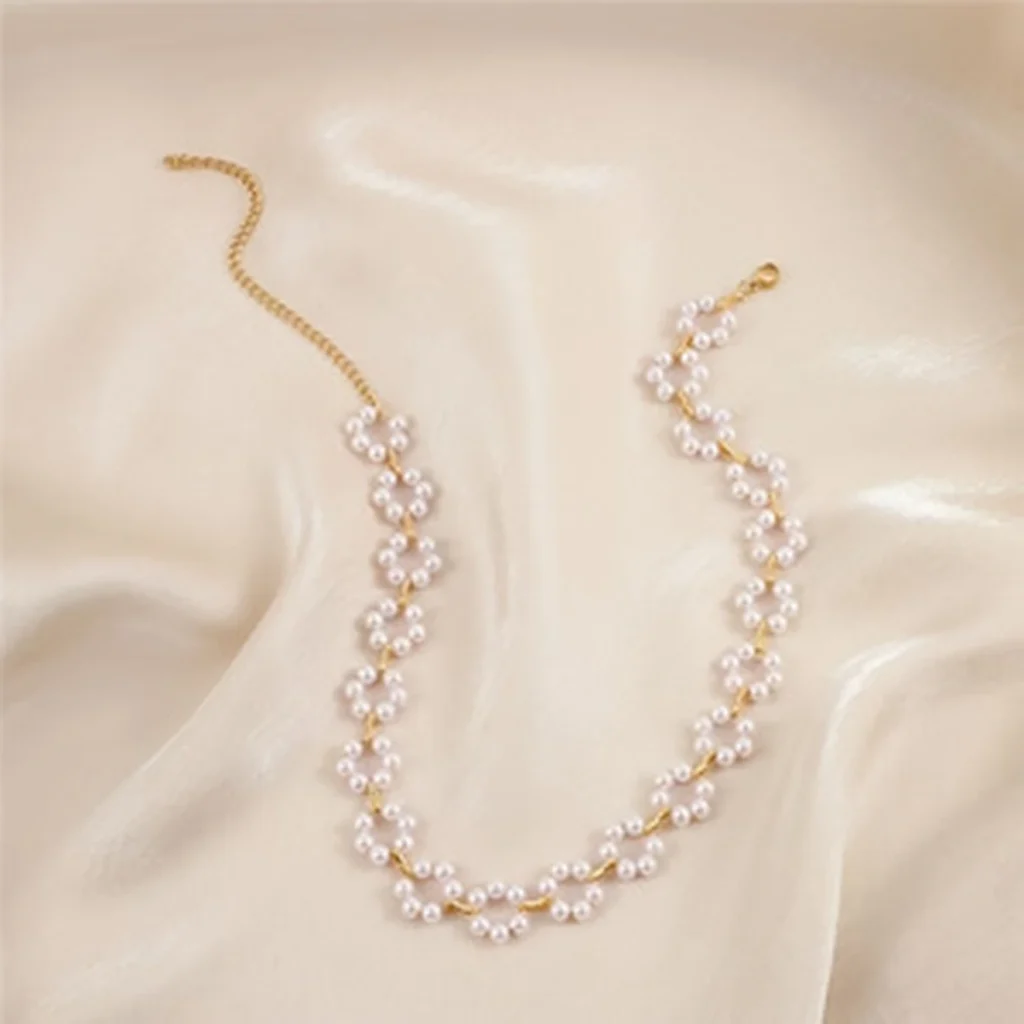 Pearl floral choker necklace arranged on silk