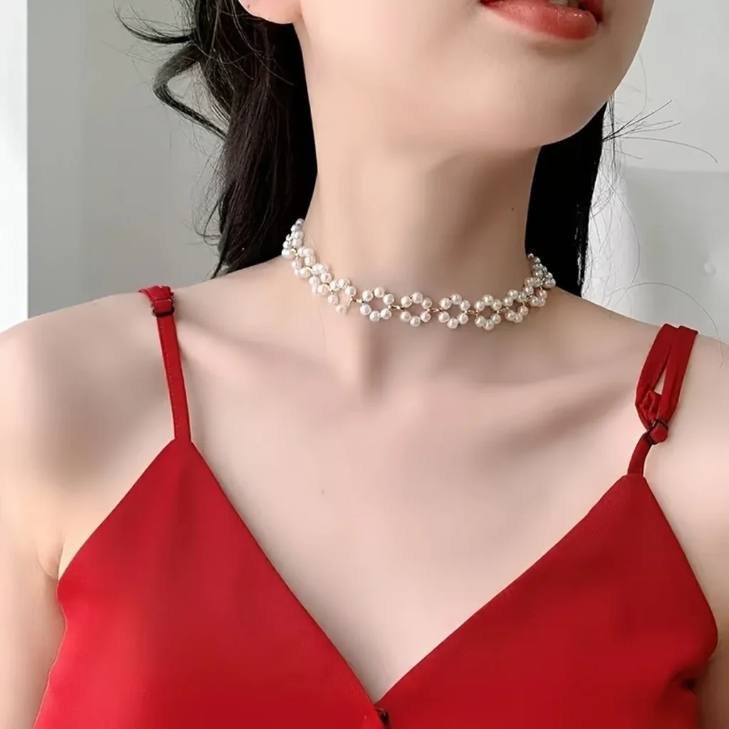 Pearl floral choker necklace worn with red top