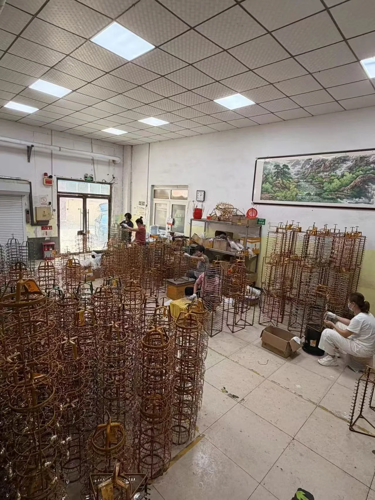Bulk jewelry parts arranged on production racks for surface finishing