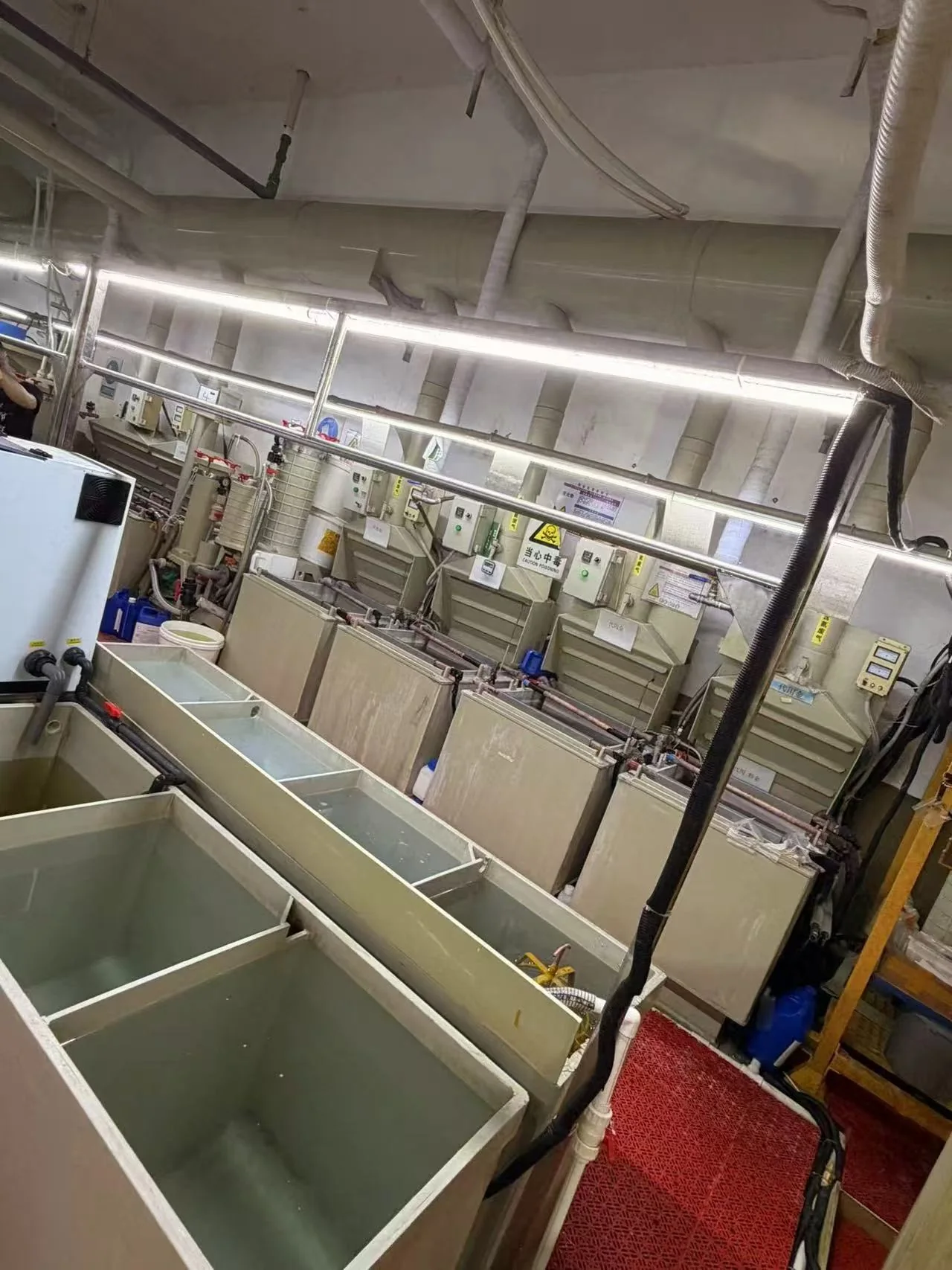 Jewelry finishing workshop with processing tanks and production equipment