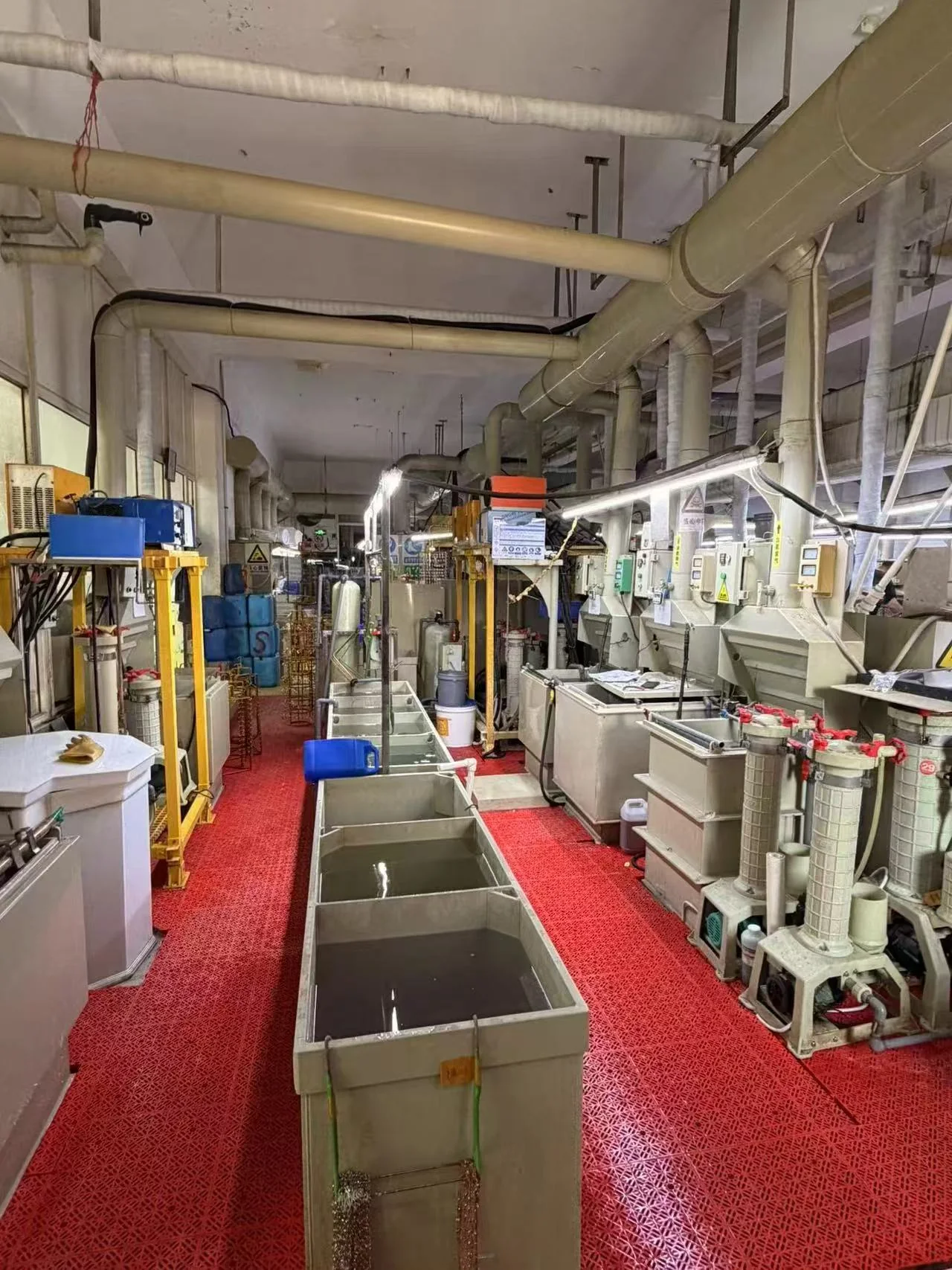 Jewelry production line with workers handling metal parts