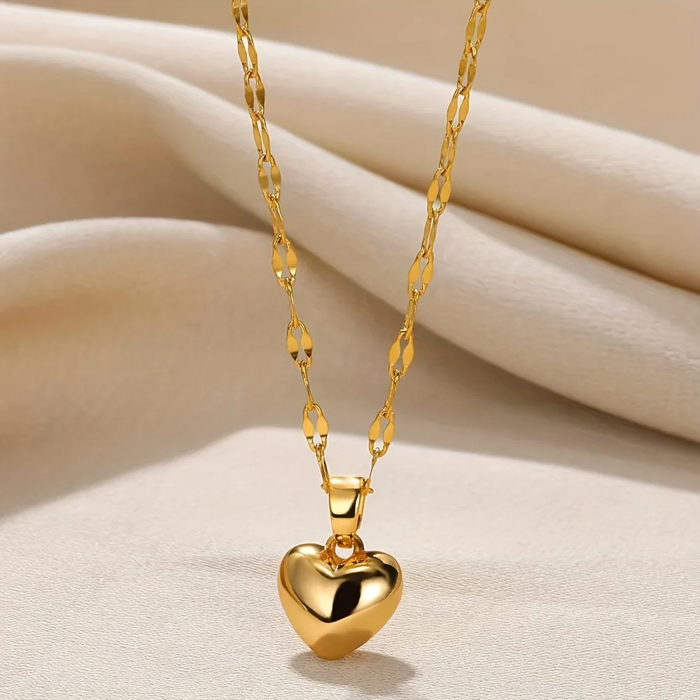 Gold-tone heart pendant with a wide bail on a linked chain