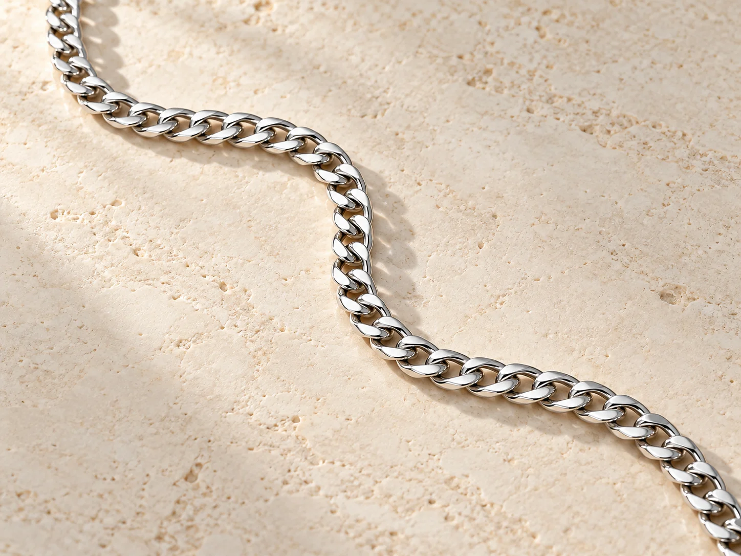 Silver-tone curb chain with flattened interlocking links