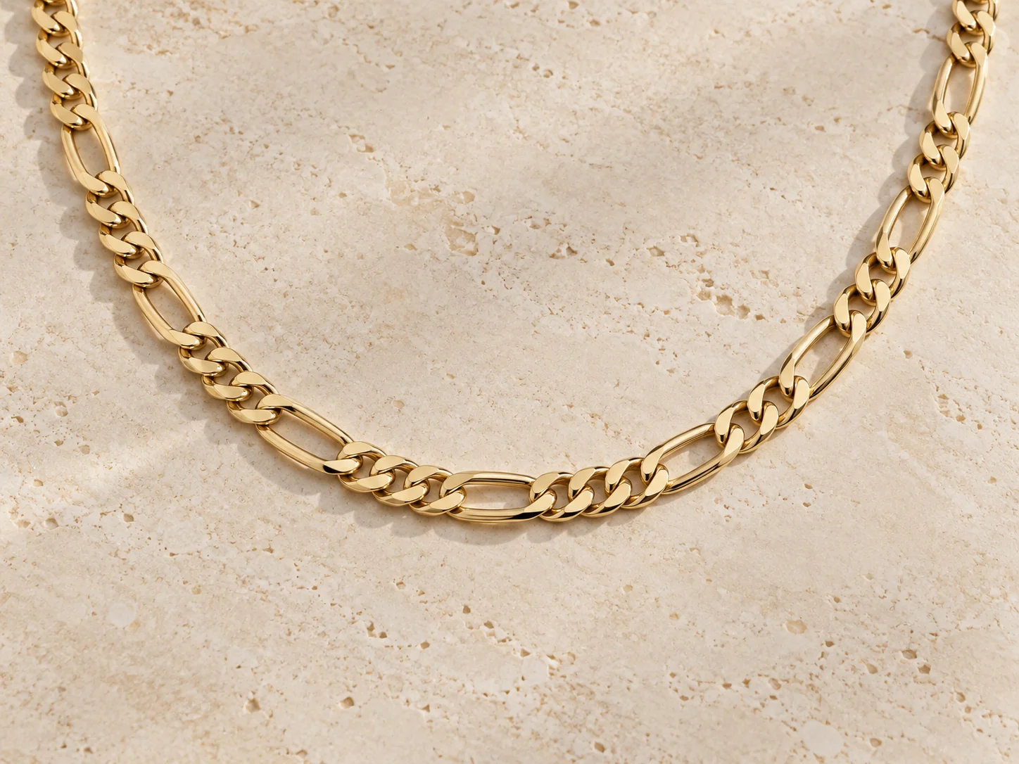 Gold-tone Figaro chain with alternating short and elongated links