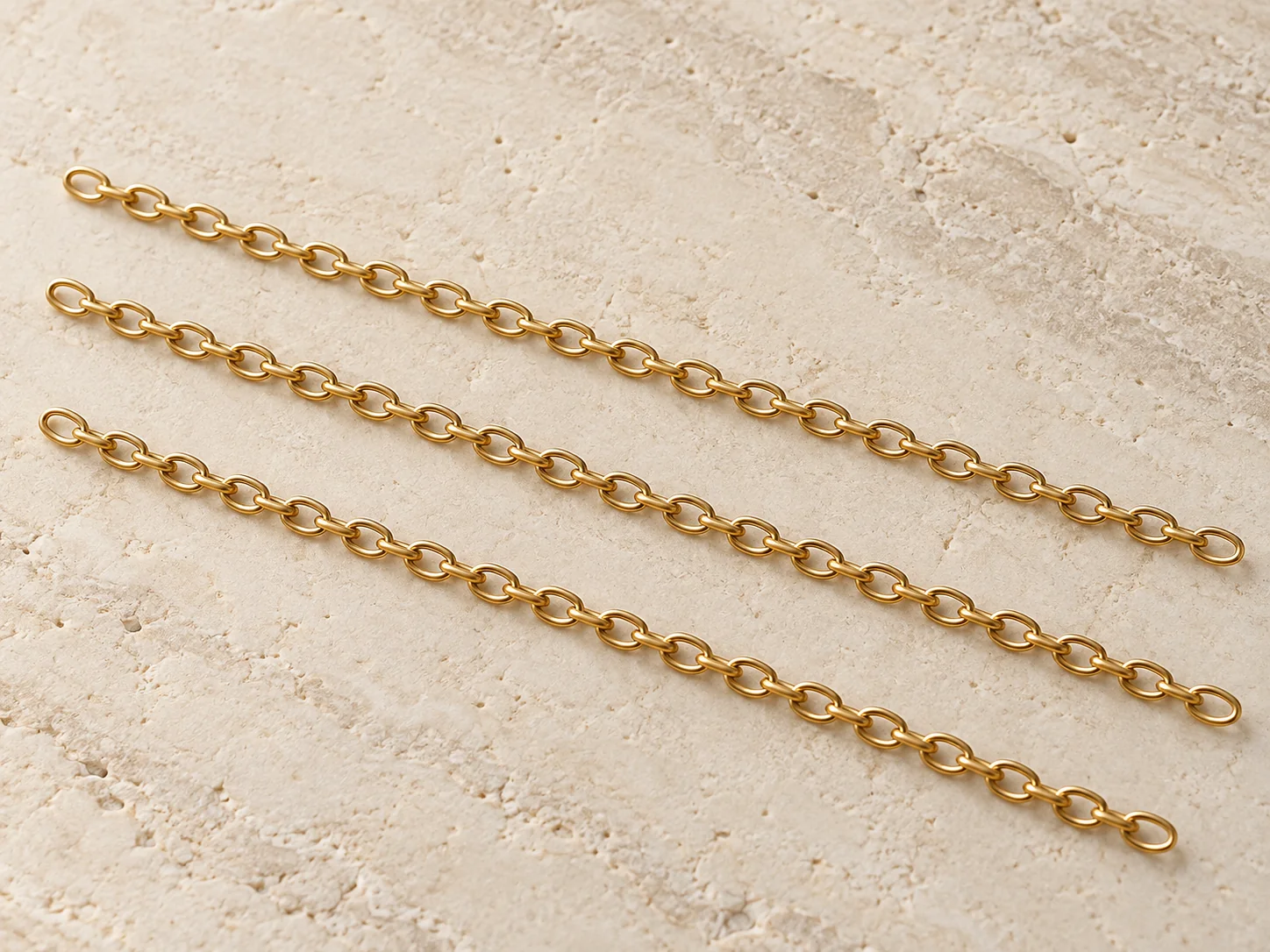 Three unfinished cable chain lengths arranged side by side