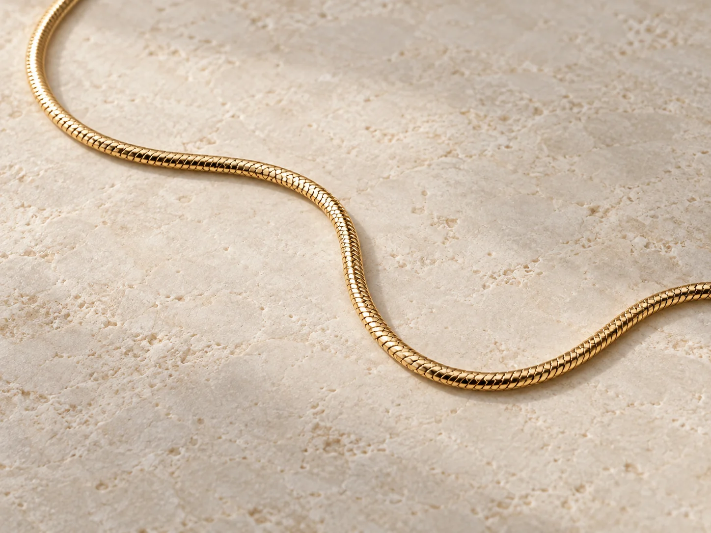 Gold-tone snake chain with a smooth continuous profile