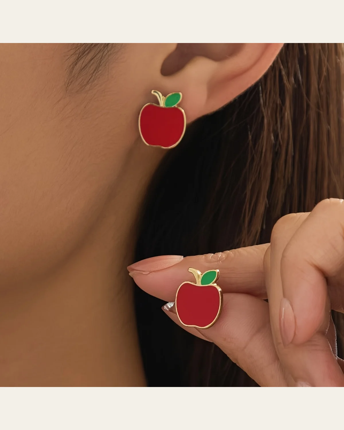 Red apple-shaped earrings shown worn with a matching apple ring