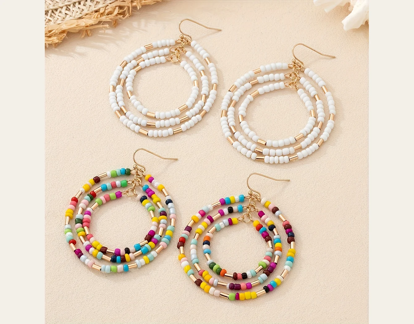 Beaded hoop earrings in light and multicolor arrangements on pale fabric