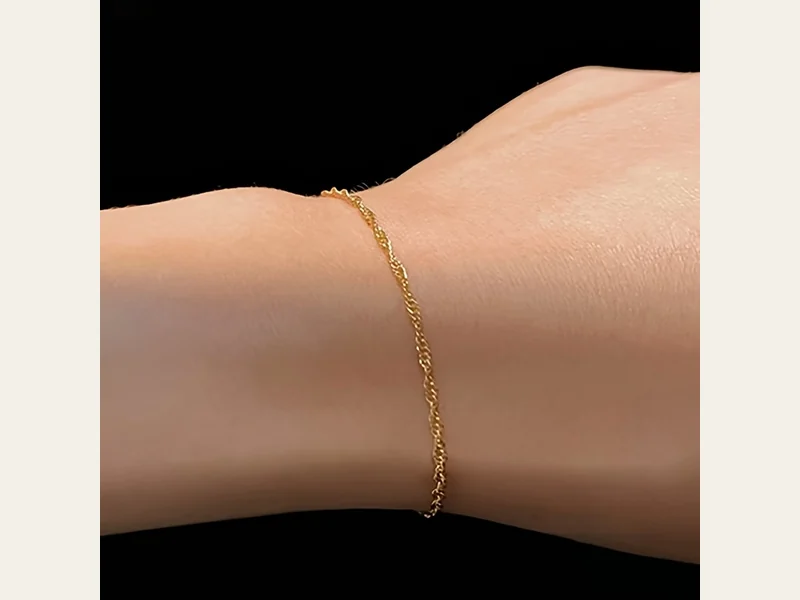 Fine gold-tone link bracelet shown as one individual jewelry style