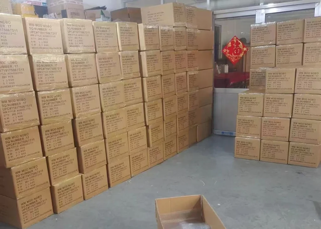 Cardboard cartons stacked beside an aisle in a storage room